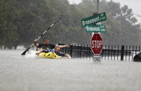 HARVEY SLIDER4 Two kayakers try to beat the current pushing them down an overflowing Brays Bayou from Tropical Storm Harvey in Houston, Texas, Sunday, Aug. 27, 2017. (Mark Mulligan/Houston Chronicle via AP)

