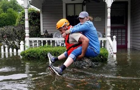 HARVEY SLIDER4 HOUSTON, TX - AUGUST 27: In this handout provided by the Army National Guard, A Texas National Guardsman carries a resident from her flooded home following Hurricane Harvey August 27, 2017 in Houston, Texas. Harvey, which made landfall north of Corpus Christi late Friday evening, is expected to dump upwards to 40 inches of rain in areas of Texas over the next couple of days. (Photo by Lt. Zachary West/Army National Guard via Getty Images)
