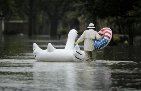 HARVEY SLIDER4 A man walks to his home in a neighborhood inundated by floodwaters from Tropical Storm Harvey on Monday, Aug. 28, 2017, in Houston, Texas. (AP Photo/Charlie Riedel)
