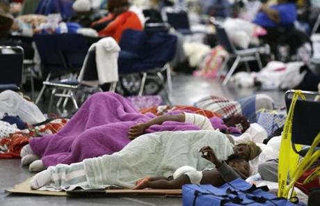 People sleep on the floor at the George R. Brown Convention Center that has been set up as a shelter for evacuees escaping the floodwaters from Tropical Storm Harvey in Houston, Texas, Tuesday, Aug. 29, 2017. (AP Photo/LM Otero)
