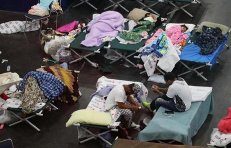 HOUSTON, TX - AUGUST 29: People take shelter at the George R. Brown Convention Center after flood waters from Hurricane Harvey inundated the city on August 29, 2017 in Houston, Texas. The evacuation center which is overcapacity has already received more than 9,000 evacuees with more arriving. (Photo by Joe Raedle/Getty Images)
