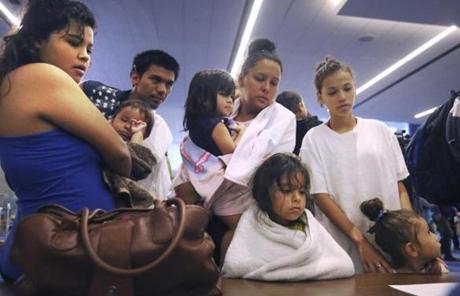 An extended family registers with relief volunteers as they make their way into the George R. Brown Convention Center after evacuation from the floodwaters from Tropical Storm Harvey in Houston, Texas, Tuesday, Aug. 29, 2017. (AP Photo/LM Otero)
