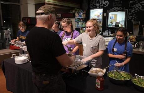 Volunteers dish out food at a dining area in Woodlands Church which has been set up as a shelter for those displaced by Hurrican Harvey in The Woodlands, Texas on August 29, 2017. Harvey has set what forecasters believe is a new rainfall record for the continental US, officials said Tuesday. Harvey, swirling for the past few days off Texas and Louisiana has dumped more than 49 inches (124.5 centimeters) of rain on the region. / AFP PHOTO / MANDEL NGANMANDEL NGAN/AFP/Getty Images
