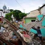 Juchitan residents searched for belongings amid the ruins of their home. 