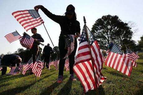 Volunteers in Weston place 3,000 flags on the Weston Town Green to commemorate those who died on 9/11 in the terrorists attacks in 2001. Suzanne Kreiter/Globe staff
