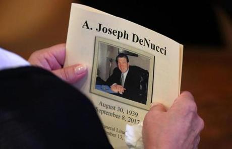 DENUCCI SLIDER Newton-09/13/17-A funeral service was held for former boxer, State Rep and State Auditor, Joe DeNucci at Our Lady Help of Christians Church. A woman holds a program in church. John Tlumacki/Globe Staff(metro)
