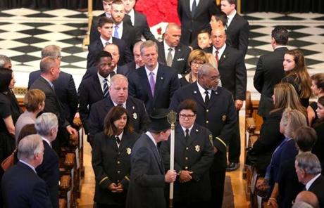 DENUCCI SLIDER Newton-09/13/17-A funeral service was held for former boxer, State Rep and State Auditor, Joe DeNucci at Our Lady Help of Christians Church. Gov. Charlie Baker in a procession in front of the casket with the Massachusetts State House officers in front at the conclusion of the service. John Tlumacki/Globe Staff(metro)
