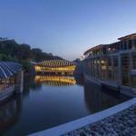 Crystal Bridges Museum with its arch-roofed pavilions that appear to float above the water