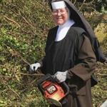 Sister Margaret Ann holds a chain saw near Miami, Fla. 