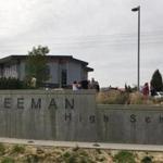 People gather outside of Freeman High School after reports of a shooting at the school in Rockford, Wash., Wednesday, Sept. 13, 2017. (KHQ via AP)