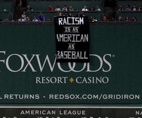 Boston, MA - 9/13/2017 - (4th inning) A banner protesting racism is unfurled over the Green Monster during the fourth inning. The Boston Red Sox host the Oakland Athletics in the second of a three game series at Fenway Park. - (Barry Chin/Globe Staff), Section: Sports, Reporter: Peter Abraham, Topic: 14Red Sox-A's, LOID: 8.3.3712452174.
