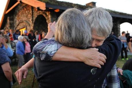 20170914 Rockport, Maine Photo by Fred J. Field Pat Shannon of Lincolnville, Maine (facing camera) was comforted by Dee Boehmer, left, also of Lincolnville shortly before a candlelight vigil was held in Rockport, Maine Thursday evening 9/14/17 in remembrance of the four Groton, Mass. victims allegedly murdered by Rockport, Maine native Orion Krause.
