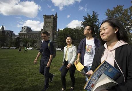 17toronto - A group of students new to The University of Toronto walk across the lawn in front of King's College at the U of T at the conclusion of a campus tour for foreign students lead by volunteers from the university's Centre for International Experience in Toronto, ON on Friday, September 8, 2017. (Peter Power for the Boston Globe)
