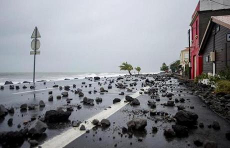 MARIA SLIDER2 TOPSHOT - A picture shows rocks swept by strong waves onto a road in Le Carbet, on the French Caribbean island of Martinique, after it was hit by Hurricane Maria, on September 19, 2017. Martinique suffered power outages but avoided major damage. / AFP PHOTO / Lionel CHAMOISEAULIONEL CHAMOISEAU/AFP/Getty Images
