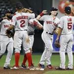 Boston Red Sox's Andrew Benintendi, second from right, celebrates with teammates after closing out a baseball game against the Baltimore Orioles in Baltimore, Monday, Sept. 18, 2017. (AP Photo/Patrick Semansky)