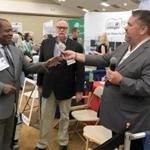 A man (left) received $300 in a cash giveaway at the Cape Cod Symposium on Addictive Disorders on Friday.