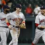 Boston Red Sox right fielder Mookie Betts, right, laughs as he runs off the field with teammates Jackie Bradley Jr., left, and Andrew Benintendi after a baseball game against the Baltimore Orioles in Baltimore, Tuesday, Sept. 19, 2017. Boston won 1-0 in 11 innings. (AP Photo/Patrick Semansky)