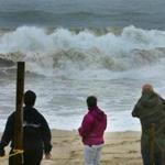 People watched the powerful surf hit Nauset Beach as high tide approached.