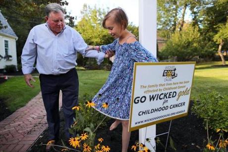 Norwell-09/13/17- Nicole Schindler, 13 of Norwell has a sixty percent chance of surviving after she was diagnosed with pediatric cancer over two and a half years ago. She underwent extreme radiation therapy at Mass General Hospital for the tumor in her head. Her father Gerald helps her after she placed a sign by Wicked Good Cause in their front yard to help raise awareness to pediatric cancer. John Tlumacki/Globe Staff(south)
