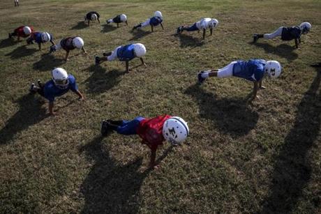 Eight- and nine-year-old Pop Warner football players practice in Pflugerville, Texas in 2015.
