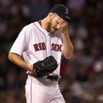 Boston, MA: September 26, 2017: Red Sox starting pitcher Chris Sale was feeling the heat in the top of the fifth inning, as he gave up three runs on two homers in the frame. The Boston Red Sox hosted the Toronto Blue Jays in an MLB regular season baseball game at Fenway Park. (Jim Davis/Globe Staff).