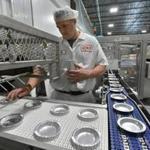 Jeff Warren, product developer for Table Talk, laid out pie tins on the assembly line at the company?s new factory in Worcester.