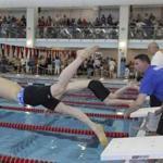 Kelvin Truong dives into the pool as coach Mike McQuay gives encouragement in ?Swim Team.?