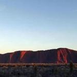 The sun rises over Uluru.