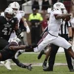 Massachusetts running back Marquis Young (8) runs through Mississippi State defenders for a first down during the first half of an NCAA college football game in Starkville, Miss., Saturday, Nov. 4, 2017. (AP Photo/Rogelio V. Solis)