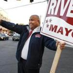 Lawrence Mayor Dan Rivera pointed at motorists at the corner of Park and Lawrence Streets in Lawrence. Rivera faces former Lawrence mayor Willie Lantigua in one of the five mayoral races outside of Boston that will be decided Tuesday.