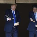 President Trump and Japanese Prime Minister Shinzo Abe fed fish during a welcoming ceremony in Tokyo on Monday. 