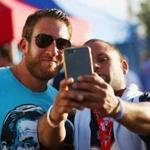 Barstool Sports founder David Portnoy (left), with a fan at a recent Patriots game in Foxborough. Barstool believes its signature brashness is a winning formula.
