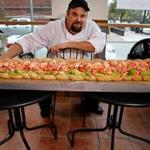 Chef Kenny Dupree poses with a 5-foot Monstah roll at Lobstah on a Roll in Boston Wednesday.