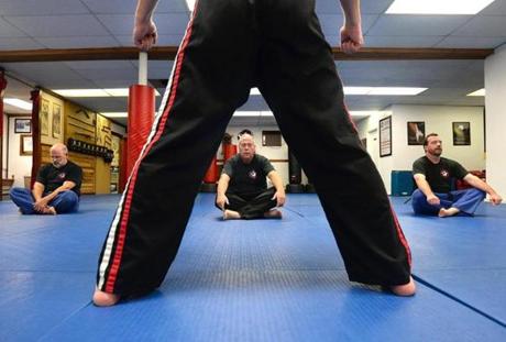 Weymouth 11/02/2017: (l-r) Victor DeRubeis (cq) of Weymouth age 61, Brian Finnerty of Weymouth, 59, and Jay Krim of Rockland 49, meditate after their Martial Arts class that was instructed by Chuck Anderson (forground) at the American Kempo Karate Academy in Weymouth. Photo by Debee Tlumacki for the Boston Globe (south) 
