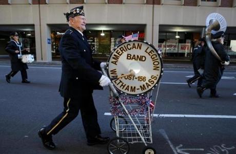 Mario Taricano played the drum while marching with the Waltham American Legion Band during the Veterans Day Parade in Boston on Saturday.
