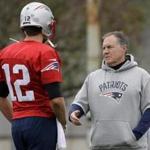 New England Patriots quarterback Tom Brady (12) speaks with head coach Bill Belichick, right, during NFL football practice, Wednesday, Nov. 1, 2017, in Foxborough, Mass. (AP Photo/Steven Senne)