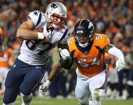 Denver CO 11/10/17 New England Patriots Rob Gronkowski turns up field after a reception with pursuit from Denver Broncos Brandon Marshall during first half action at Sports Authority Field at Mile High Stadium . (Matthew J. Lee/Globe staff) topic reporter: 
