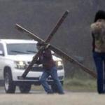 A man pulled a cross to the service in Sutherland Springs, Texas, for victims of the shooting at First Baptist Church.