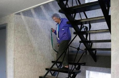 Doris Toohey, 85, walked down the stairs at her condo in Brighton with her dog, Bonnie.

