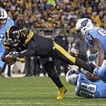 Pittsburgh Steelers quarterback Ben Roethlisberger (7) dives for extra yardage after being tackled by Tennessee Titans outside linebacker Brian Orakpo (98) during the first half of an NFL football game in Pittsburgh.