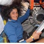 Astronaut Sunita L. Williams, a Needham native, looks over a procedures checklist in the Quest Airlock of the International Space Station. -- Library Tag 06232007 Metro