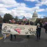 People carry signs during a protest for Puerto Rico on November 19, 2017 in Washington,DC. Puerto Ricans protested in Washington on Sunday in solidarity with their hurricane-hit island, criticizing the US response to the storm and calling for changes to be made. Hurricane Maria slammed into Puerto Rico in September, ravaging its infrastructure. Some 50 percent of its population of 3.4 million people is still without electricity more than two months later.Demonstrators gathered at the US Capitol building, with Puerto Rican flags and signs that read 