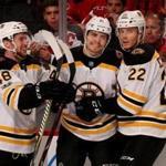 NEWARK, NJ - NOVEMBER 22: Jake DeBrusk #74 of the Boston Bruins is congratulated by teammates Matt Grzelcyk #48 and Peter Cehlarik #22 after DeBrusk scored a goal in the first period against the New Jersey Devils on November 22, 2017 at Prudential Center in Newark, New Jersey. (Photo by Elsa/Getty Images)