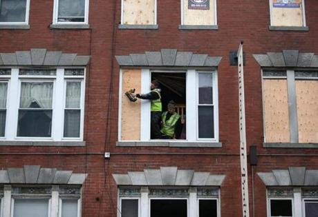 11/22/2017 Boston - Ma -. Workers board up windows at 282 Hanover Street in Boston's North End. Their was a tragic fire in building that killed two people. Jonathan Wiggs\Globe Staff Reporter:Topic. 
