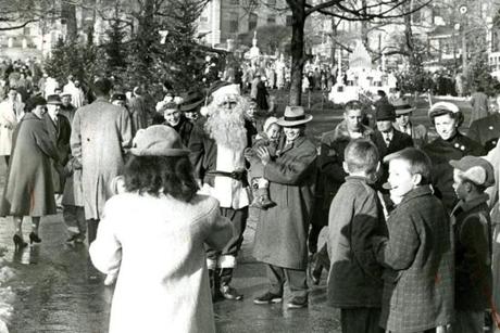 December 16 1956 / fromthearchive / Globe staff photo by Paul J. Connell / Globe Santa attracts a crowd of people wanting to have pictures taken with him. This was the inaugural year of the Boston Globe Santa Claus Fund. The Boston Post started the Santa Fund in 1910. When the Post closed earlier this year, The Boston Globe with Mayor John Hynes continued the long tradition of providing Christmas toys for needy families.

