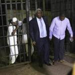 Zimbabwe's former finance minister, Ignatius Chombo (left), and Kudzanai Chipanga were led to a prison truck at the magistrates courts in Harare on Saturday. 