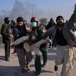 An injured protester was carried away from clashes with police in Islamabad on Saturday.