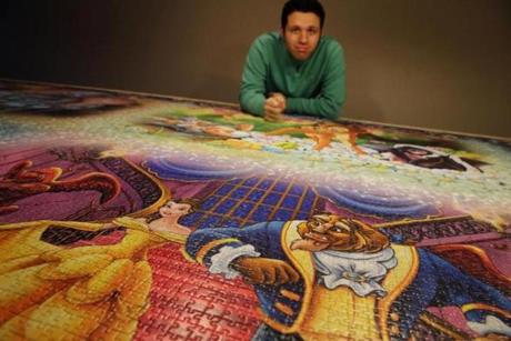 Jack Brait posed for a portrait with his completed Ravensburger Puzzle at his home in Marshfield. 
