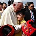 Pope Francis was greeted Monday by children dressed in traditional clothing after his arrival in Myanmar.