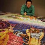 Jack Brait posed for a portrait with his completed Ravensburger Puzzle at his home in Marshfield. 